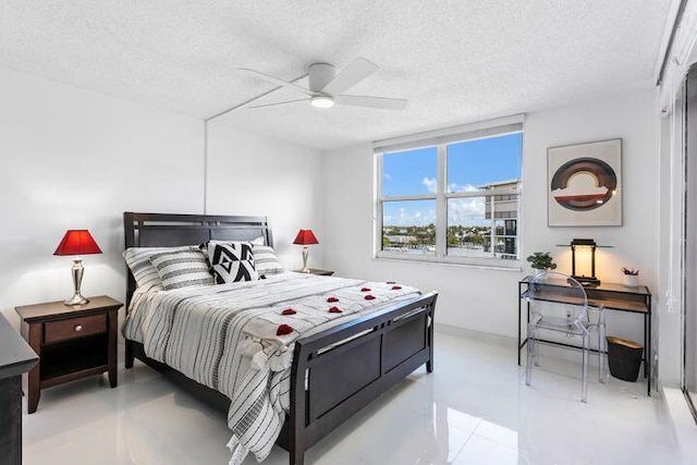 bedroom with light tile patterned floors, a textured ceiling, and ceiling fan