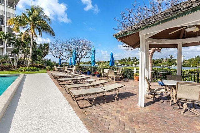 view of swimming pool with a gazebo, ceiling fan, and a patio area