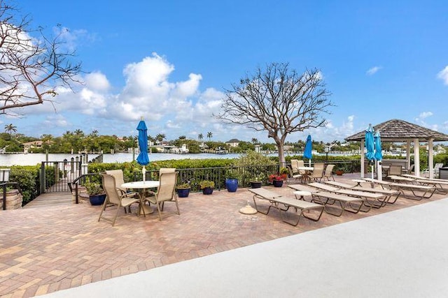 view of patio with a gazebo and a water view