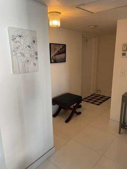 hallway featuring light tile patterned flooring