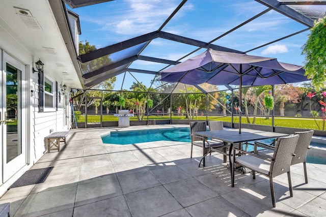 view of pool featuring a patio area and glass enclosure