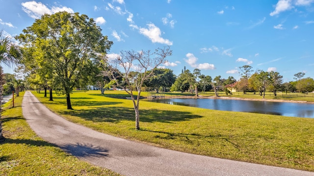 view of home's community featuring a lawn and a water view