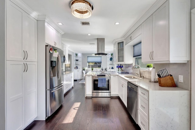 kitchen featuring white cabinetry, appliances with stainless steel finishes, a wealth of natural light, and island range hood