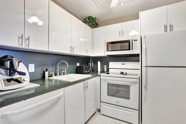 kitchen with white appliances, sink, decorative backsplash, and white cabinets