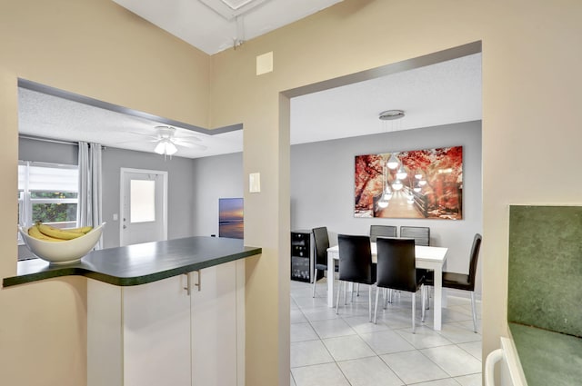 kitchen with pendant lighting, ceiling fan, and light tile patterned floors