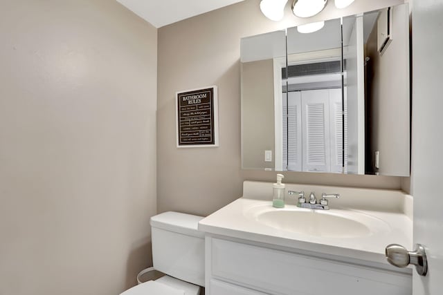 bathroom featuring vanity and toilet