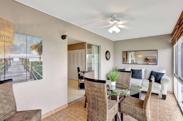 tiled dining space with ceiling fan