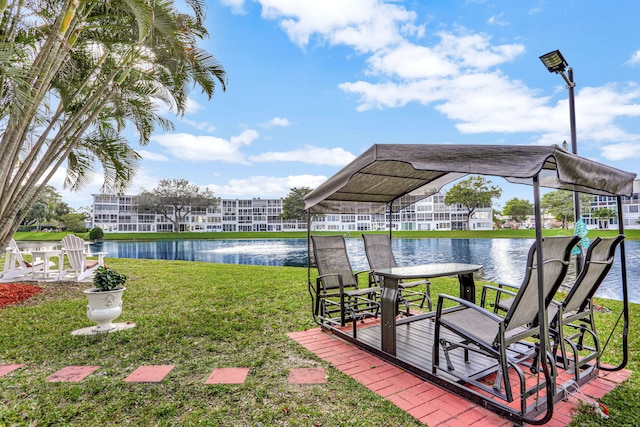 dock area with a water view and a yard