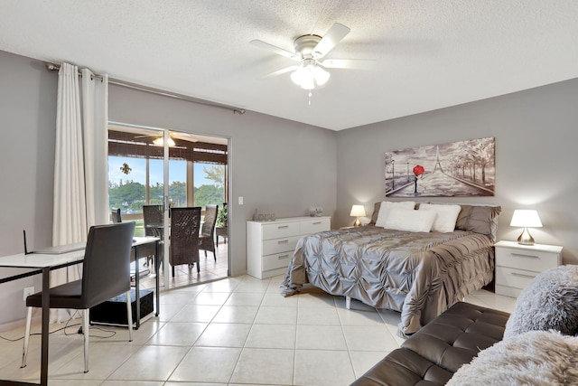 tiled bedroom with ceiling fan, access to outside, and a textured ceiling