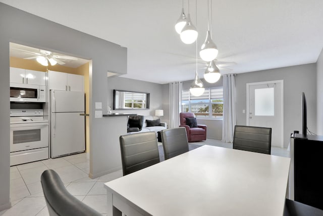 dining area with light tile patterned floors and ceiling fan