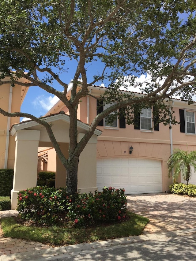 view of front of property with central AC unit and a garage