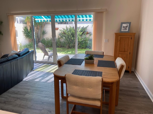 dining area with dark hardwood / wood-style flooring and a healthy amount of sunlight