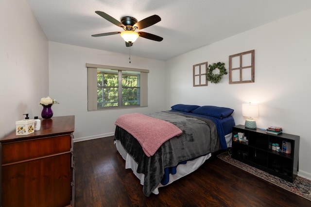 bedroom with dark hardwood / wood-style floors and ceiling fan