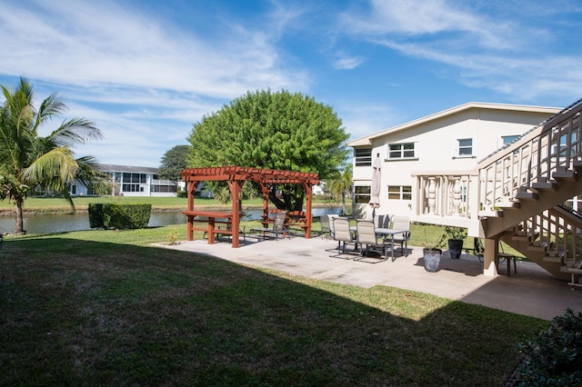 view of yard featuring a pergola, a patio, and a water view