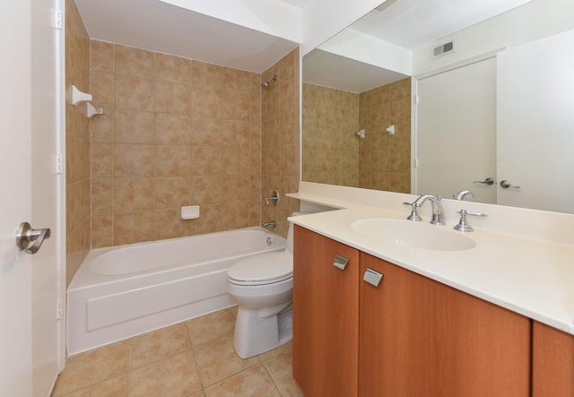 full bathroom featuring vanity, toilet, tiled shower / bath combo, and tile patterned flooring