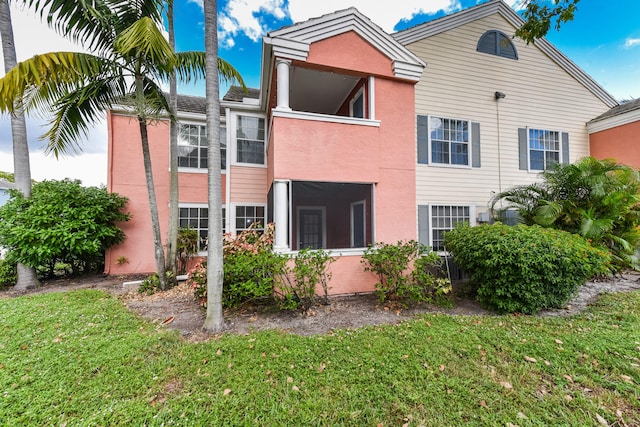 rear view of house with a yard