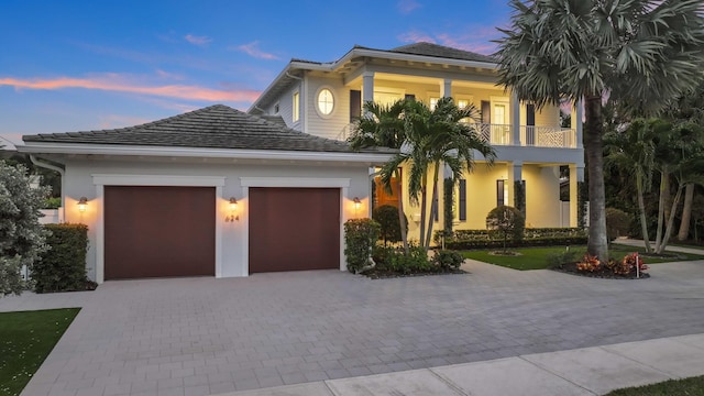 view of front of house with a garage and a balcony