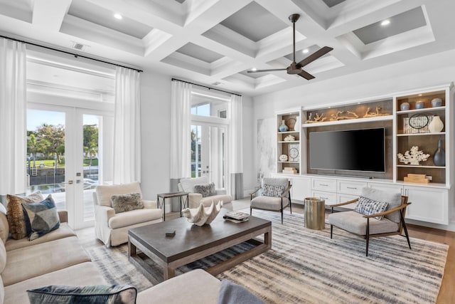 living room featuring a high ceiling, coffered ceiling, beam ceiling, and french doors