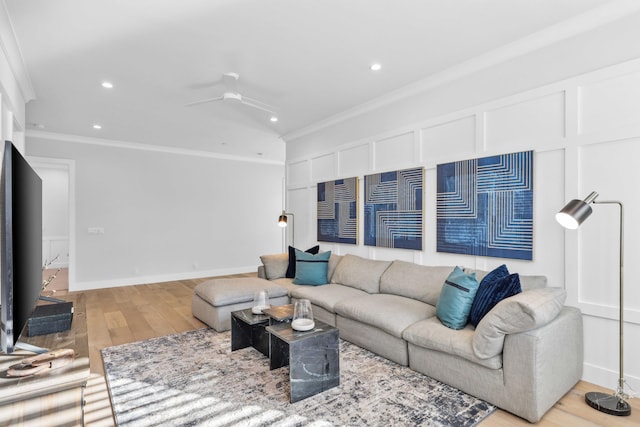 living room with ornamental molding, light hardwood / wood-style floors, and ceiling fan