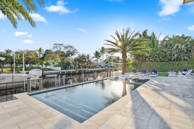 view of pool featuring a patio and a water view