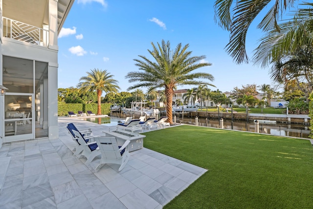 view of yard with a water view and a patio