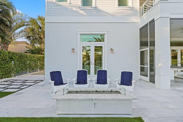 view of patio featuring french doors and a fire pit