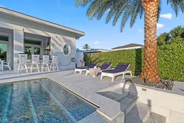 view of swimming pool featuring a patio area