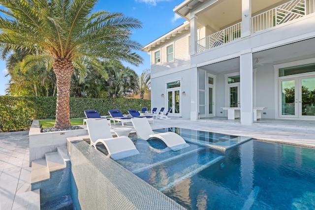 view of swimming pool featuring french doors, ceiling fan, and a patio area