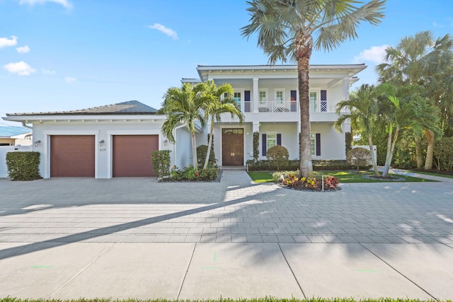 view of front of home with a garage and a balcony