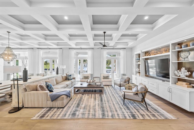 living room with a wealth of natural light, light hardwood / wood-style flooring, and french doors