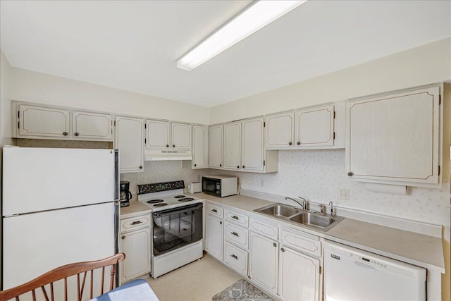 kitchen featuring sink and white appliances