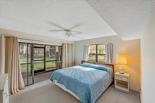 carpeted bedroom featuring a textured ceiling and ceiling fan