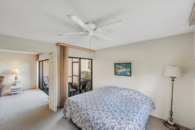 carpeted bedroom with ceiling fan and a textured ceiling