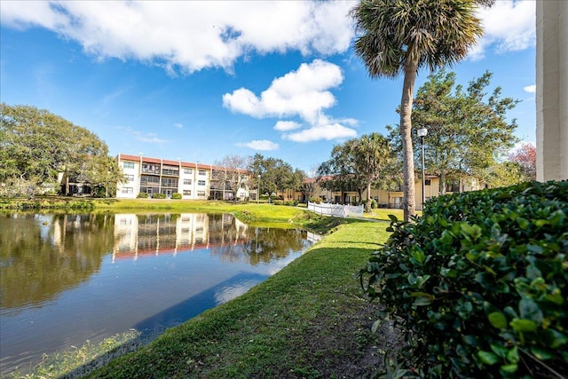 view of property's community featuring a water view and a lawn