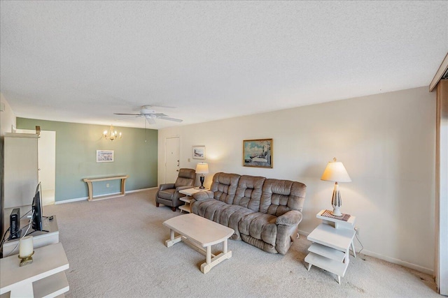 carpeted living room with ceiling fan and a textured ceiling