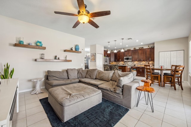 tiled living room with ceiling fan