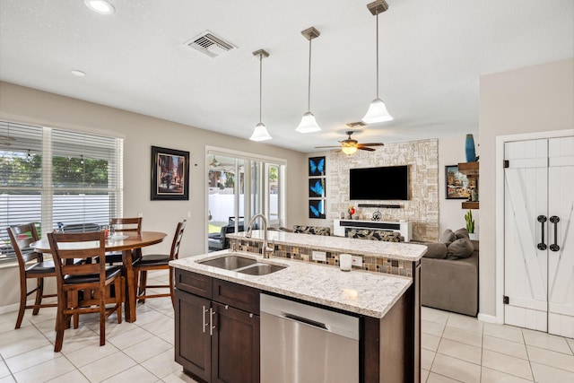 kitchen with sink, dishwasher, dark brown cabinets, an island with sink, and decorative light fixtures