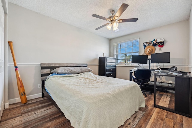 bedroom with ceiling fan, dark hardwood / wood-style floors, and a textured ceiling