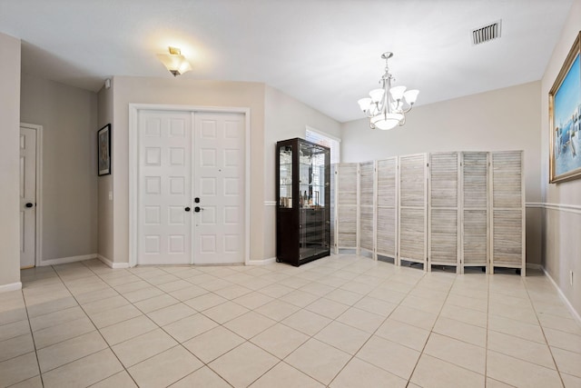 entrance foyer with a notable chandelier and light tile patterned floors