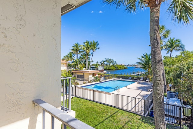 view of swimming pool with a water view and a patio