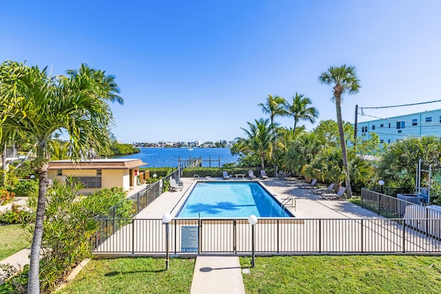 view of pool with a patio and a water view