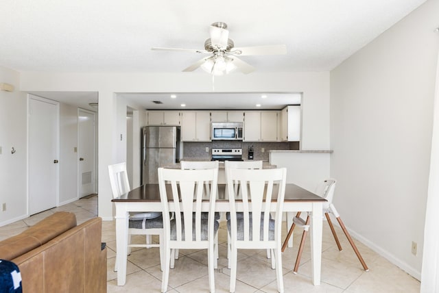 dining room with light tile patterned floors and ceiling fan