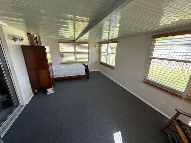 unfurnished bedroom with dark carpet