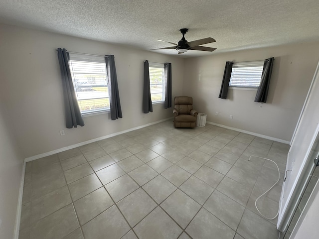 unfurnished room featuring ceiling fan and a textured ceiling