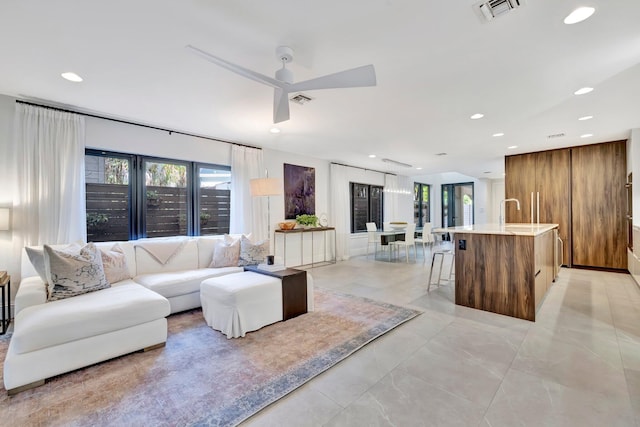 living room with ceiling fan and a wealth of natural light