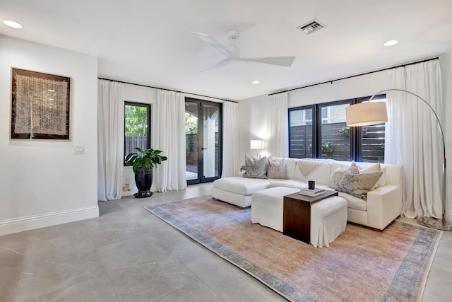 living room featuring ceiling fan and plenty of natural light