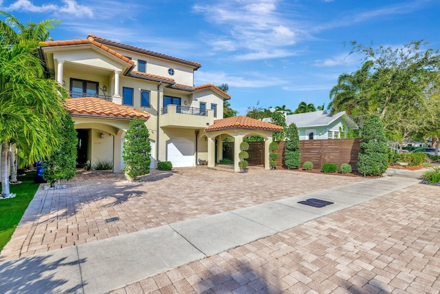 mediterranean / spanish-style home featuring a balcony and a garage