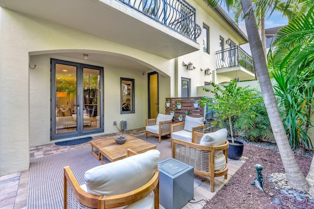 view of patio featuring french doors, a balcony, and outdoor lounge area