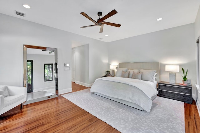 bedroom with ceiling fan and light wood-type flooring