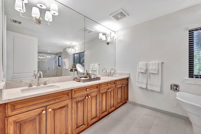 bathroom featuring an inviting chandelier, vanity, and independent shower and bath